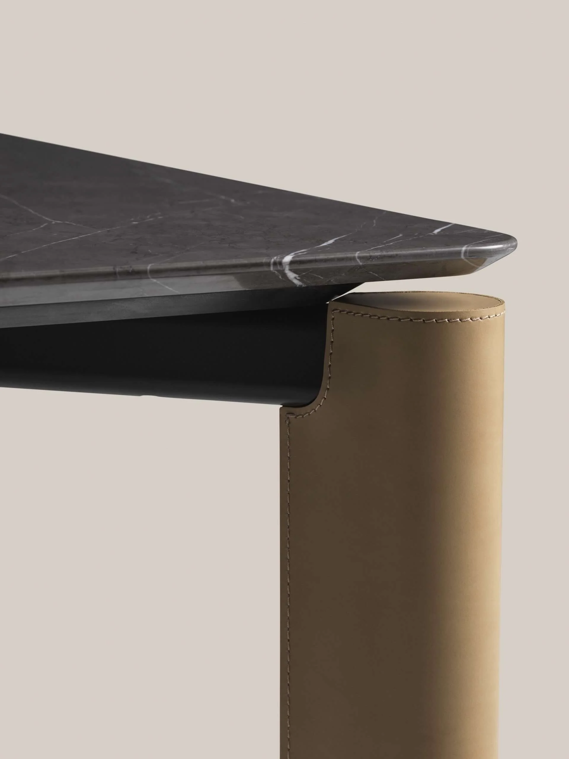 Frag Blom Italian black marble table top detail with stitched leather-wrapped cylindrical leg, premium modern design at ArkNova Interiors Paphos showroom in Cyprus