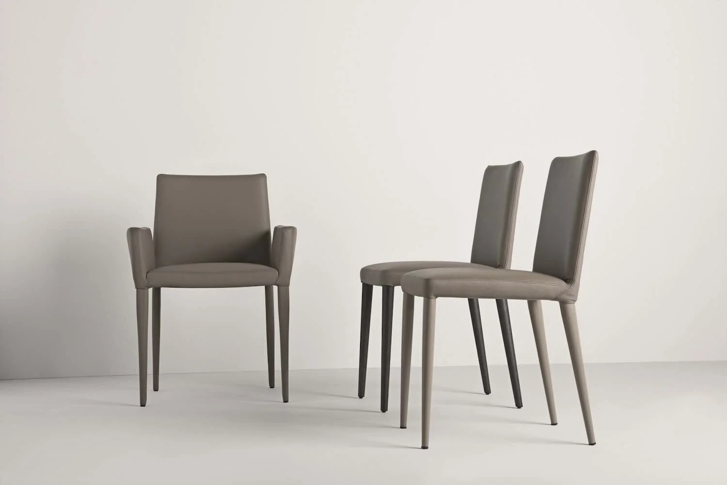 Frag Bella H GM Italian gray upholstered dining chairs with armrest and side versions at ArkNova Interiors Paphos showroom in Cyprus