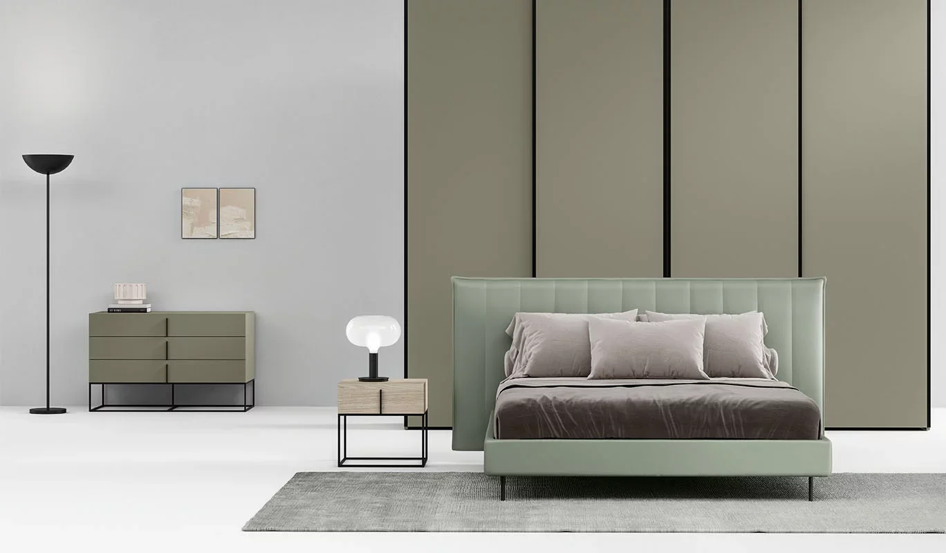 Italian Tempo bed by Cinquepuntozero with soft light green padded headboard at ArkNova Interiors Paphos showroom in Cyprus
