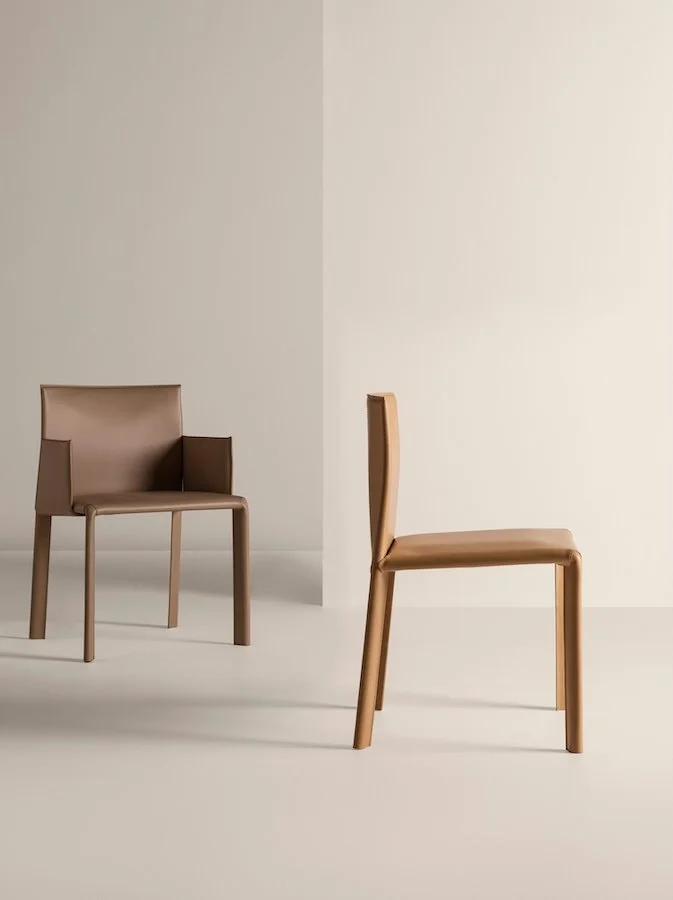 Frag Blyn Italian beige leather dining chairs with clean modern design at ArkNova Interiors Paphos showroom in Cyprus