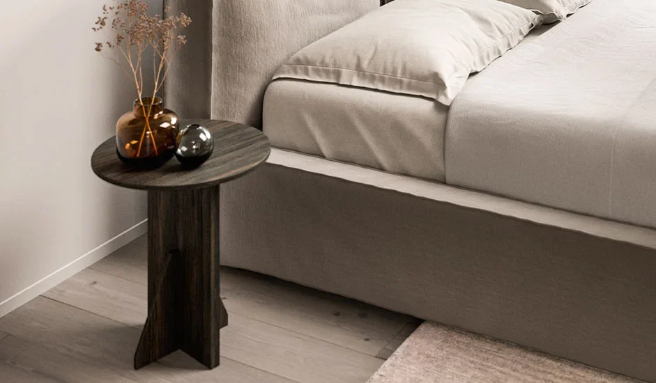 Cinquepuntozero Rea Italian dark wood round side table next to beige sofa, contemporary design at ArkNova Interiors Paphos showroom in Cyprus