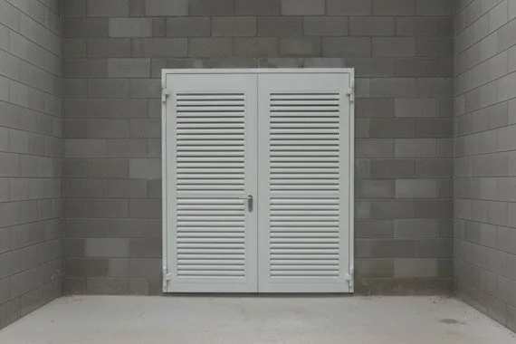 Novoferm Elite+ Finned Italian white louvered metal double doors against concrete wall at ArkNova Interiors Paphos Cyprus