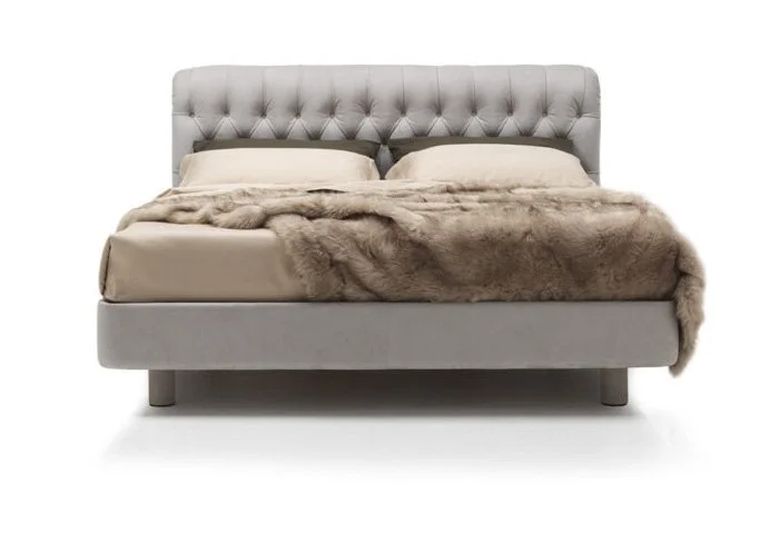 Italian Minosse bed by Albani Divani with luxurious gray tufted headboard and thick upholstered frame at ArkNova Interiors Paphos Cyprus