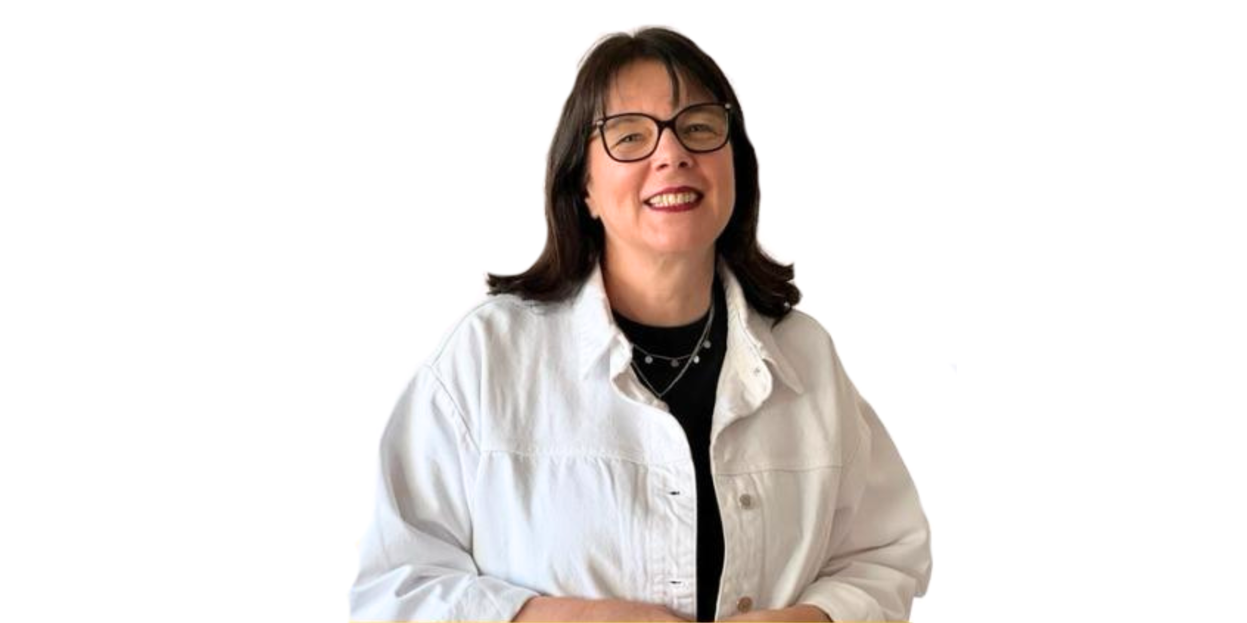A woman with dark brown hair, glasses, and a light-colored denim jacket, smiling at the camera against a plain white background.