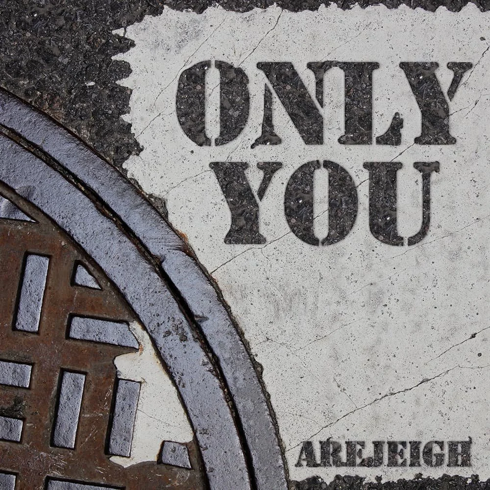 Close-up of a manhole cover with the words 'ONLY YOU' and some Cyrillic characters, partially visible.