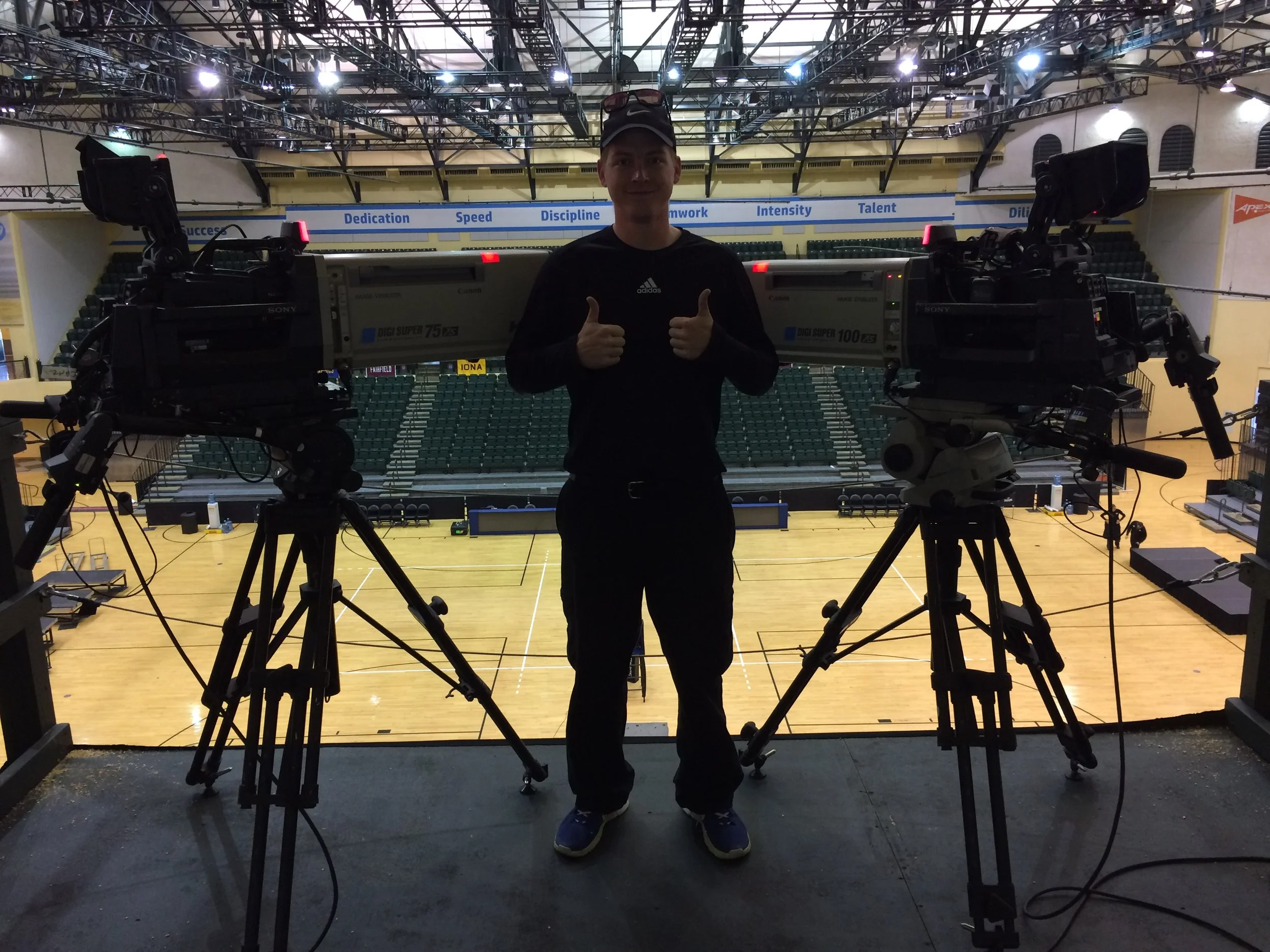 Andrew Henkelman poses after building two sports broadcast cameras for a broadcast. He enjoys building and operating so he can optimize and prepare for potential issues, vs just operate.