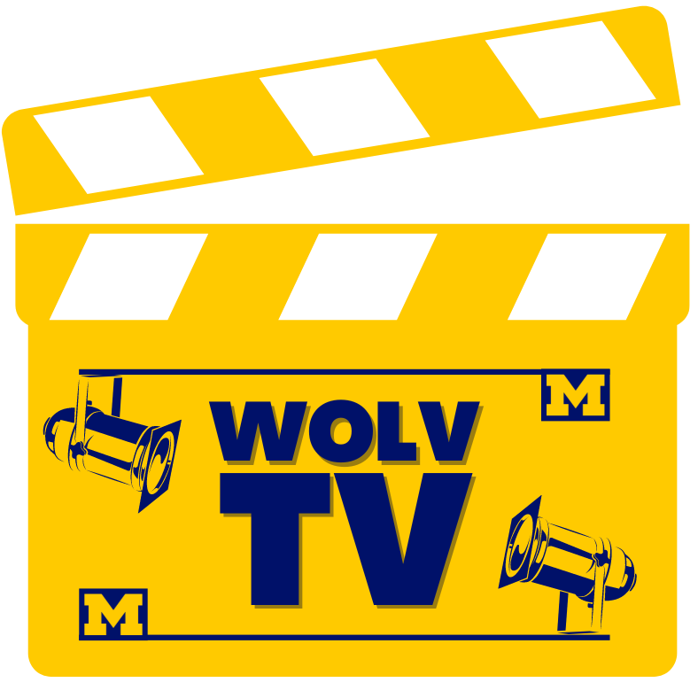 A yellow and black clapperboard with the text "WOLV TV" and images of film cameras and Michigan Wolverines logos.