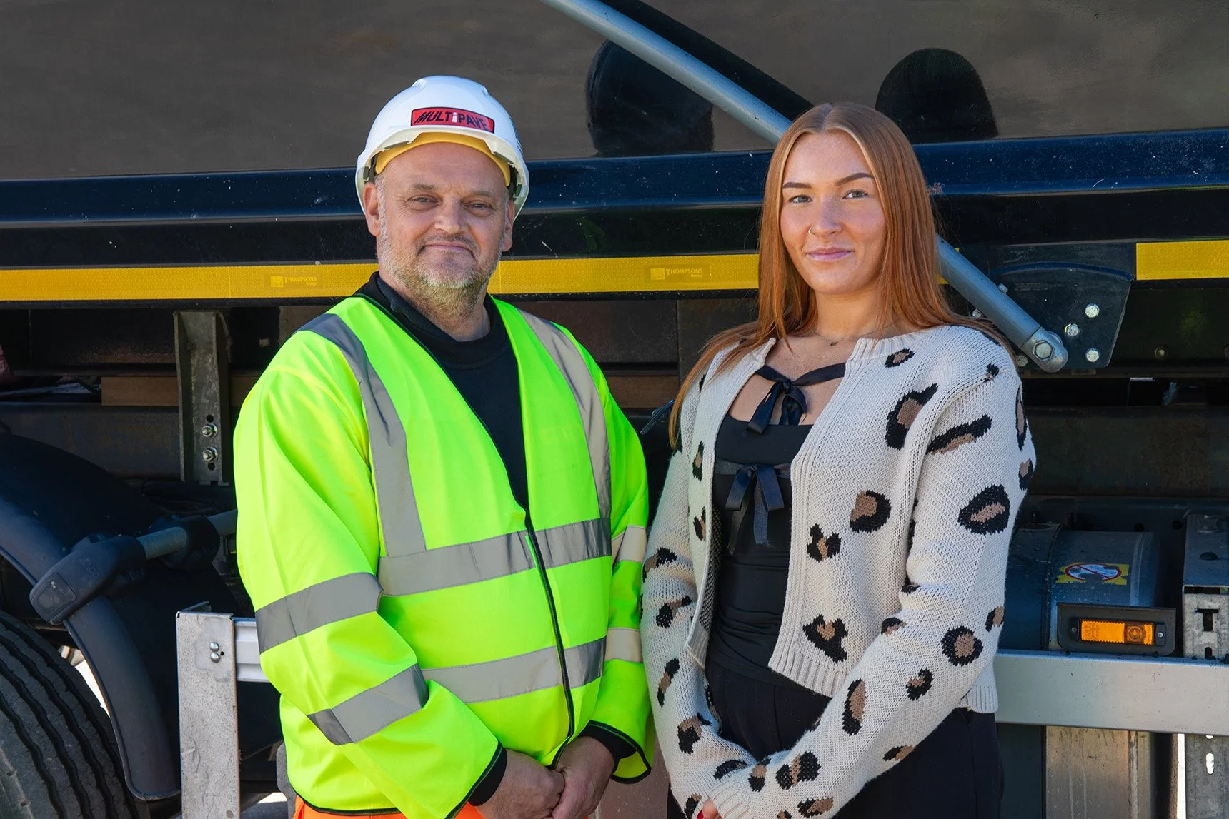 White male in full PPE standing next to a white female dressed in office wear