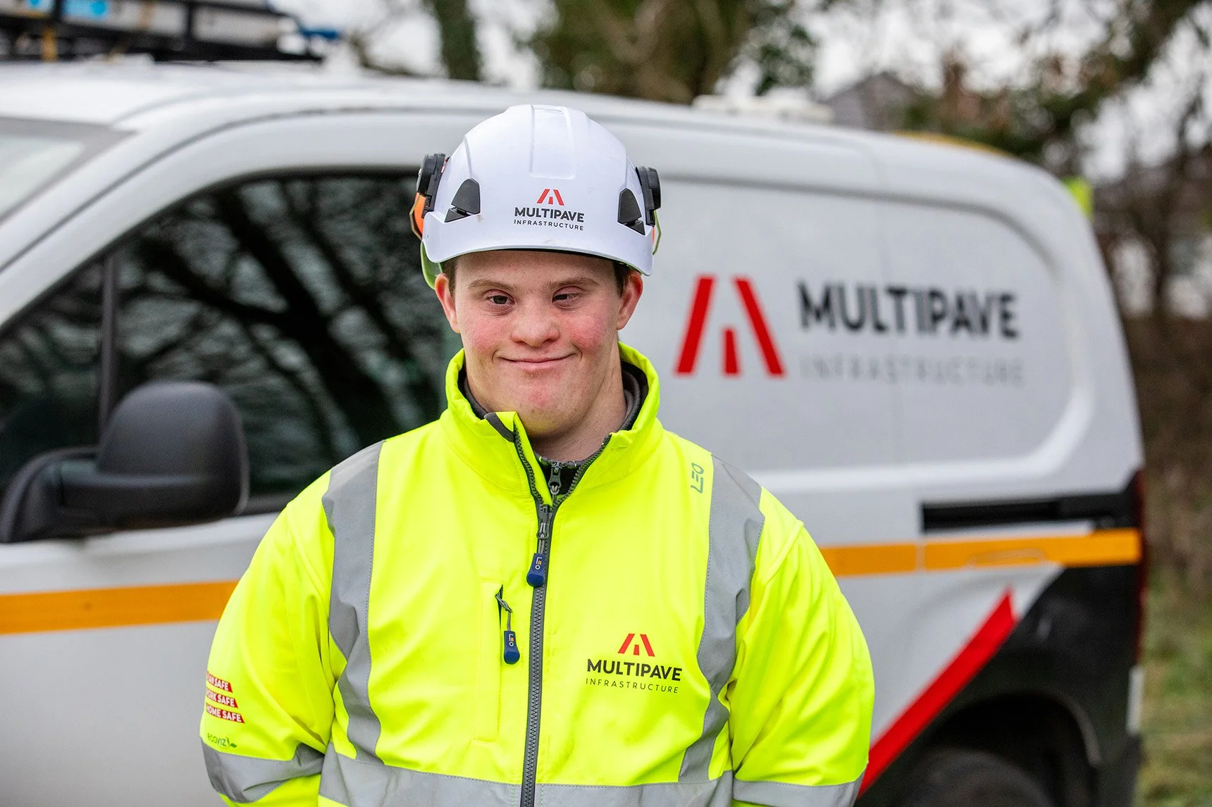 White male with full PPE standing in front of a Multipave branded van
