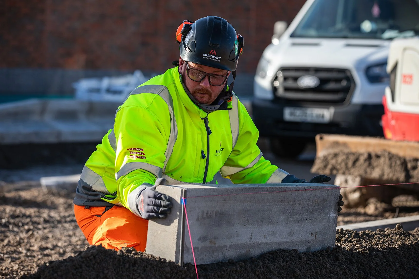 White male with full PPE working on site