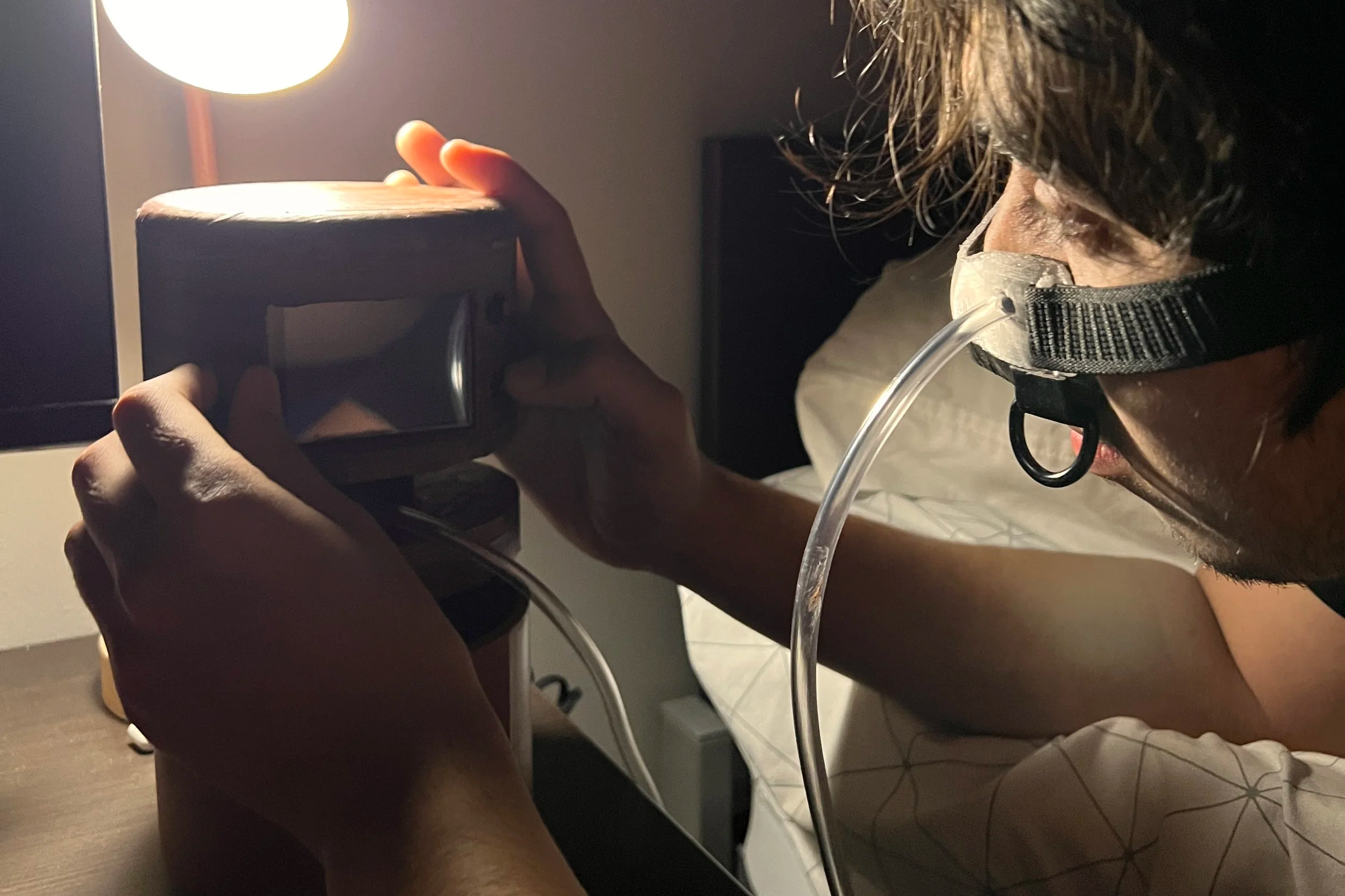 An image of a person adjusting a sleep apnea machine