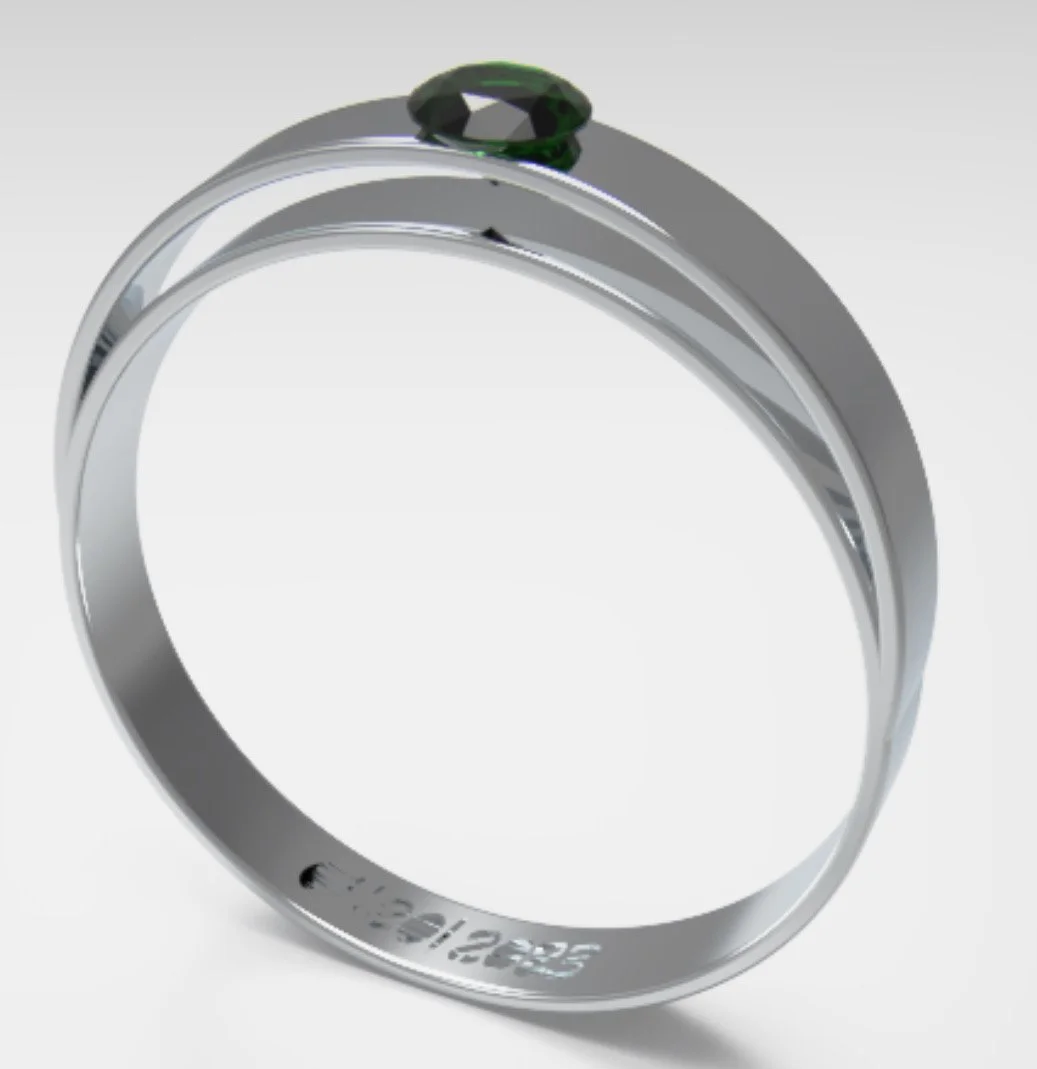 Silver ring with a black and green gemstone on top