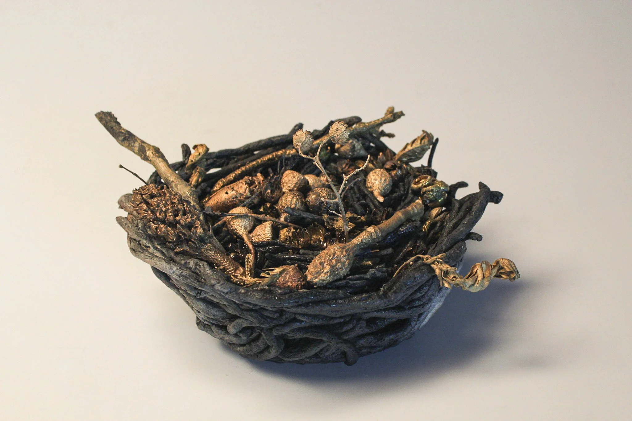 "Molting" (nest - back)
2025
Saggar-fired ceramic, bronze-cast organic material
7” x 6” x 5”