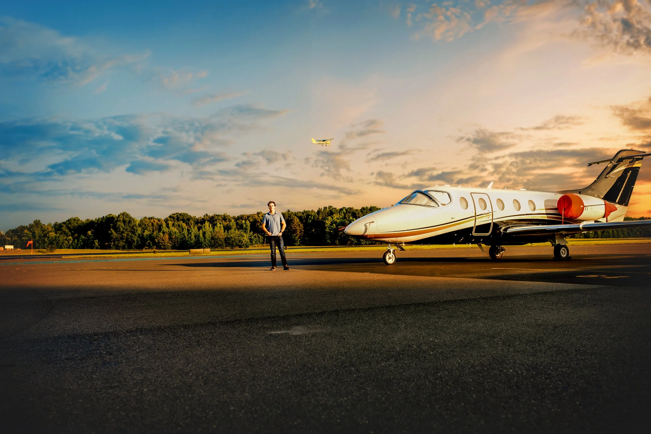 Airplane on the tarmac at sunset at Monroe Executive Airport during Zach’s senior portrait session