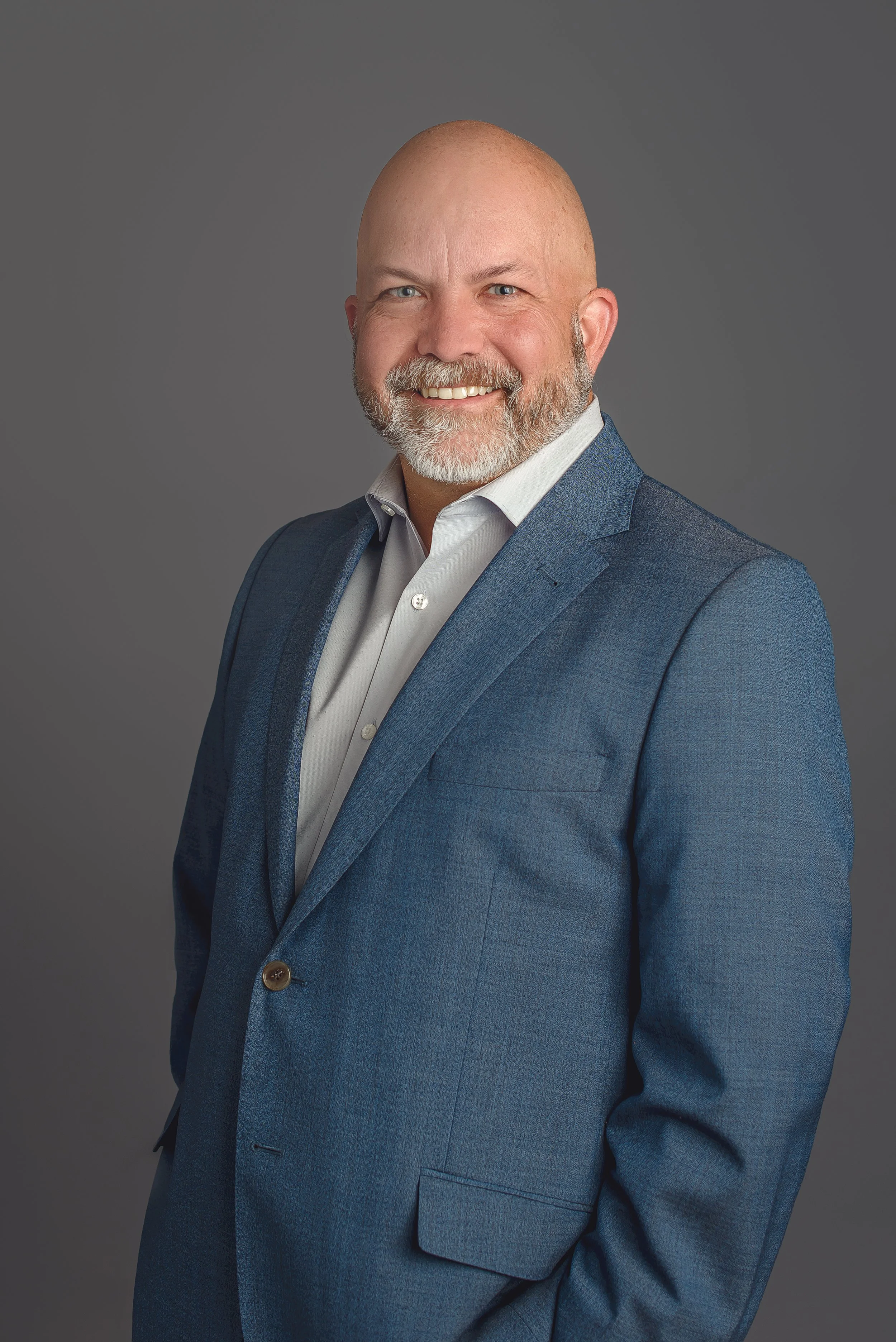 charlotte-nc-executive-headshot-men-blue-suit-gray-background.jpg