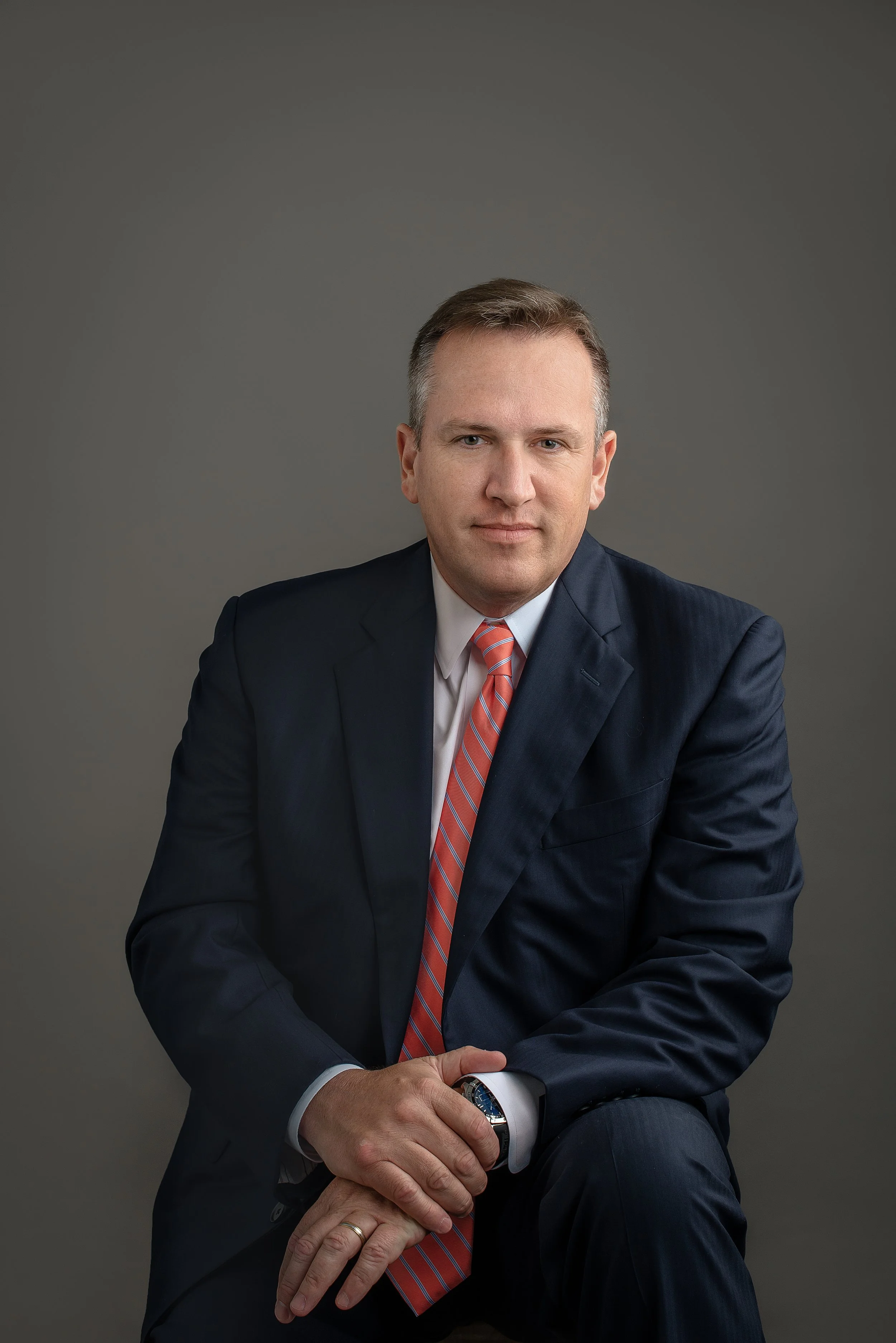 charlotte-nc-corporate-headshot-navy-suit-orange-tie.jpg
