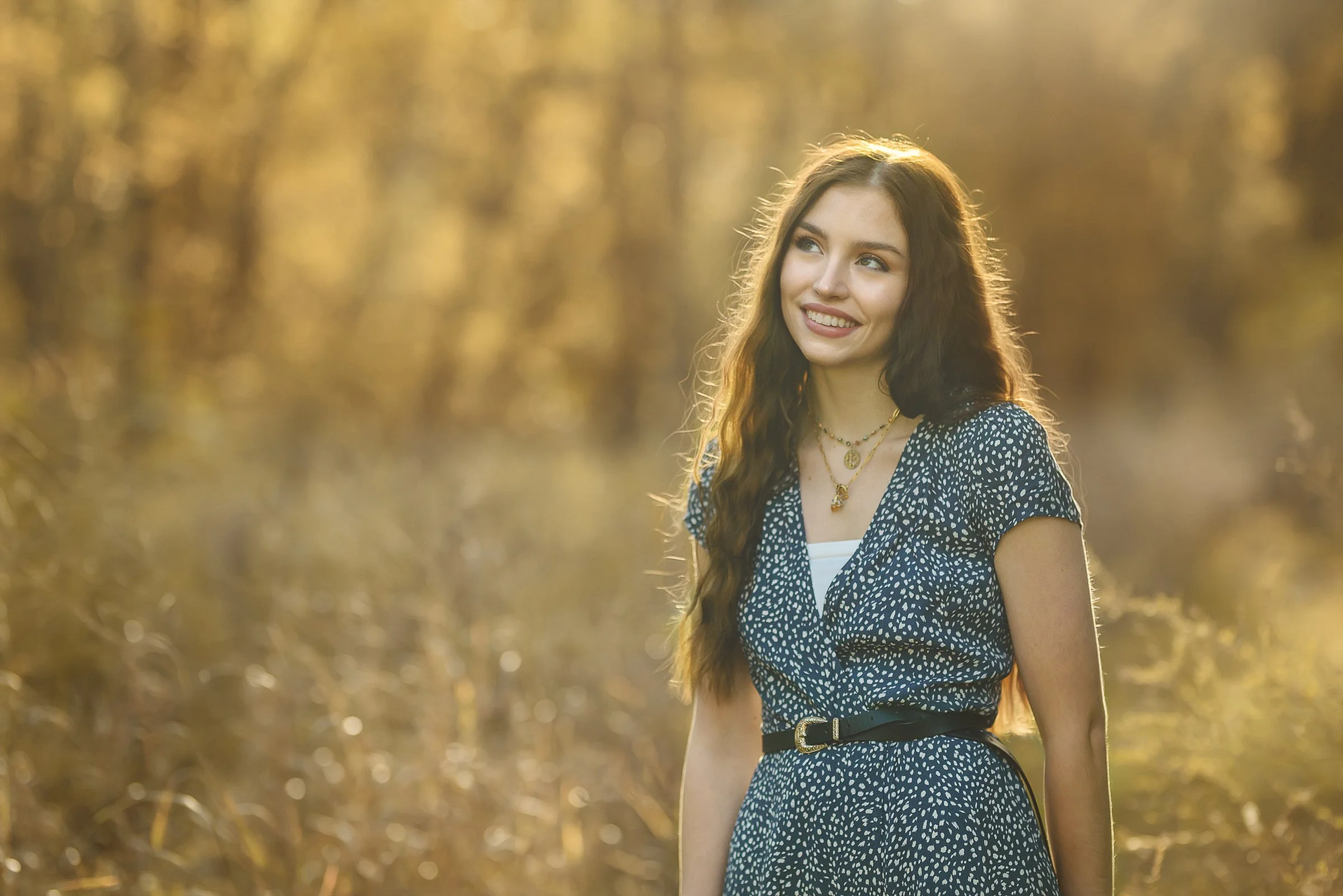 harrisburg nc senior girl photographed in summer golden field with backlight on hair in blue and white dress