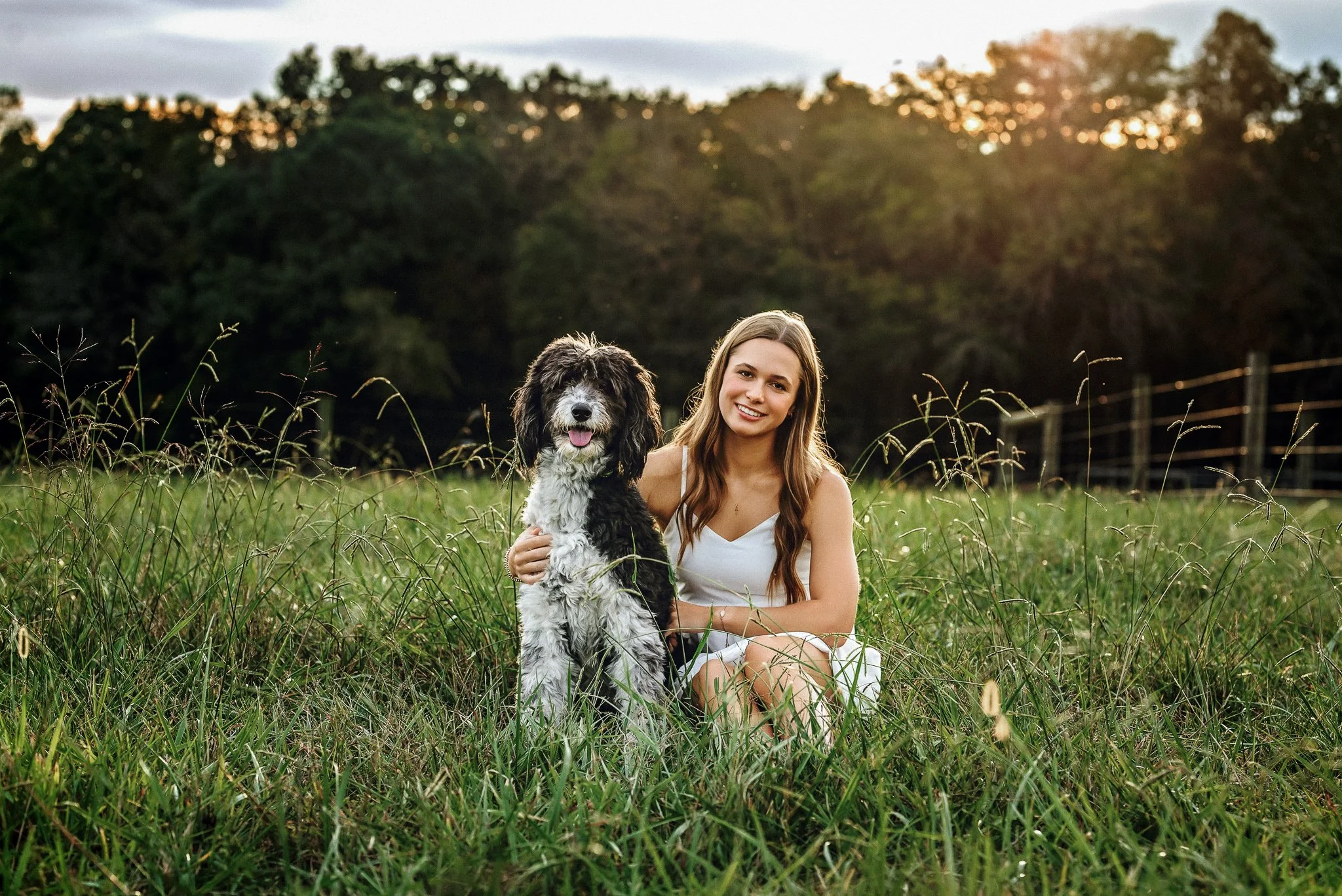 mount pleasant senior girl in white dress photographed in field with dog