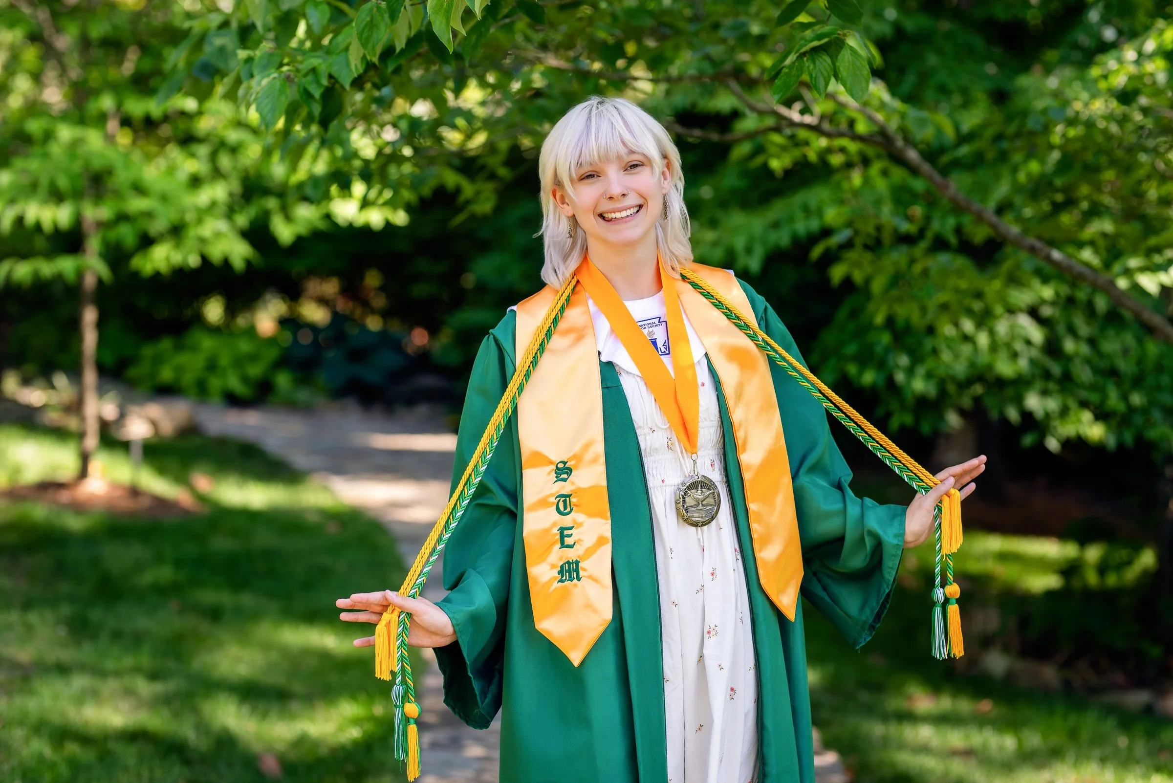 Charlotte NC senior graduation portraits - senior in cap and gown outdoors