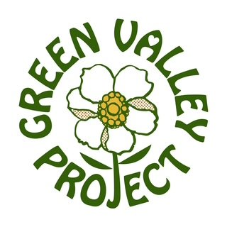 Logo for the Green Valley Project, featuring a white flower with a yellow center and green leaves, surrounded by the words 'Green Valley Project' in green text.