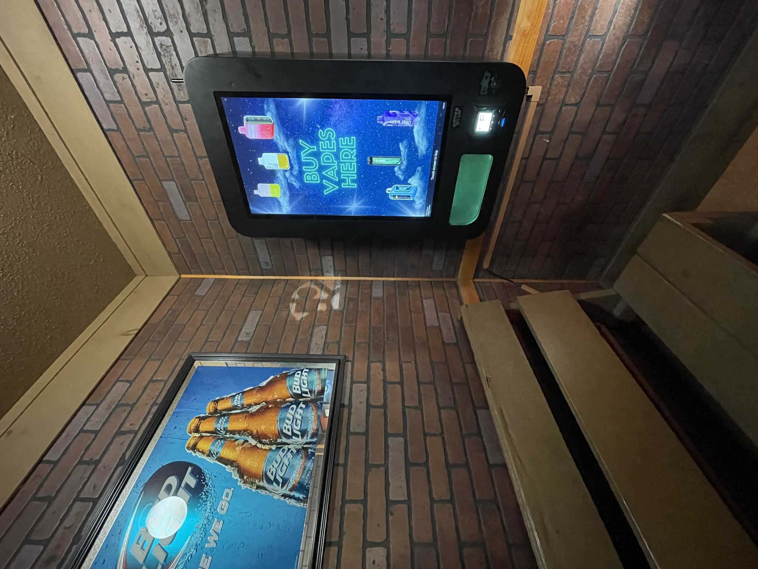 In-venue vape vending kiosk installed in a bar with promotional signage, offering guests quick access to vape products without leaving the establishment.