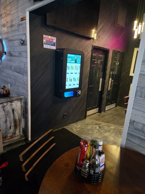 Self-service touchscreen kiosk installed in a bar or restaurant setting, demonstrating how in-venue vending solutions integrate seamlessly into nightlife spaces.