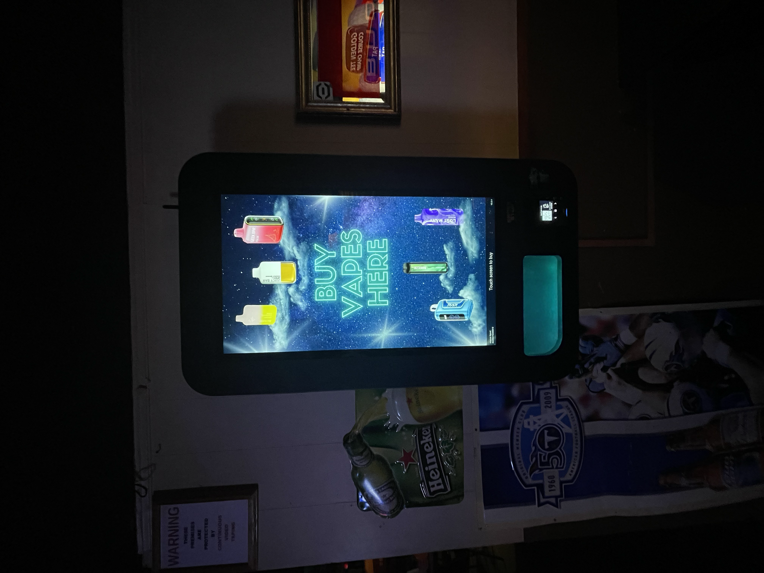 Touchscreen vape vending machine featuring a space-themed interface and “Buy Vapes Here” messaging, designed for bars and nightlife venues.