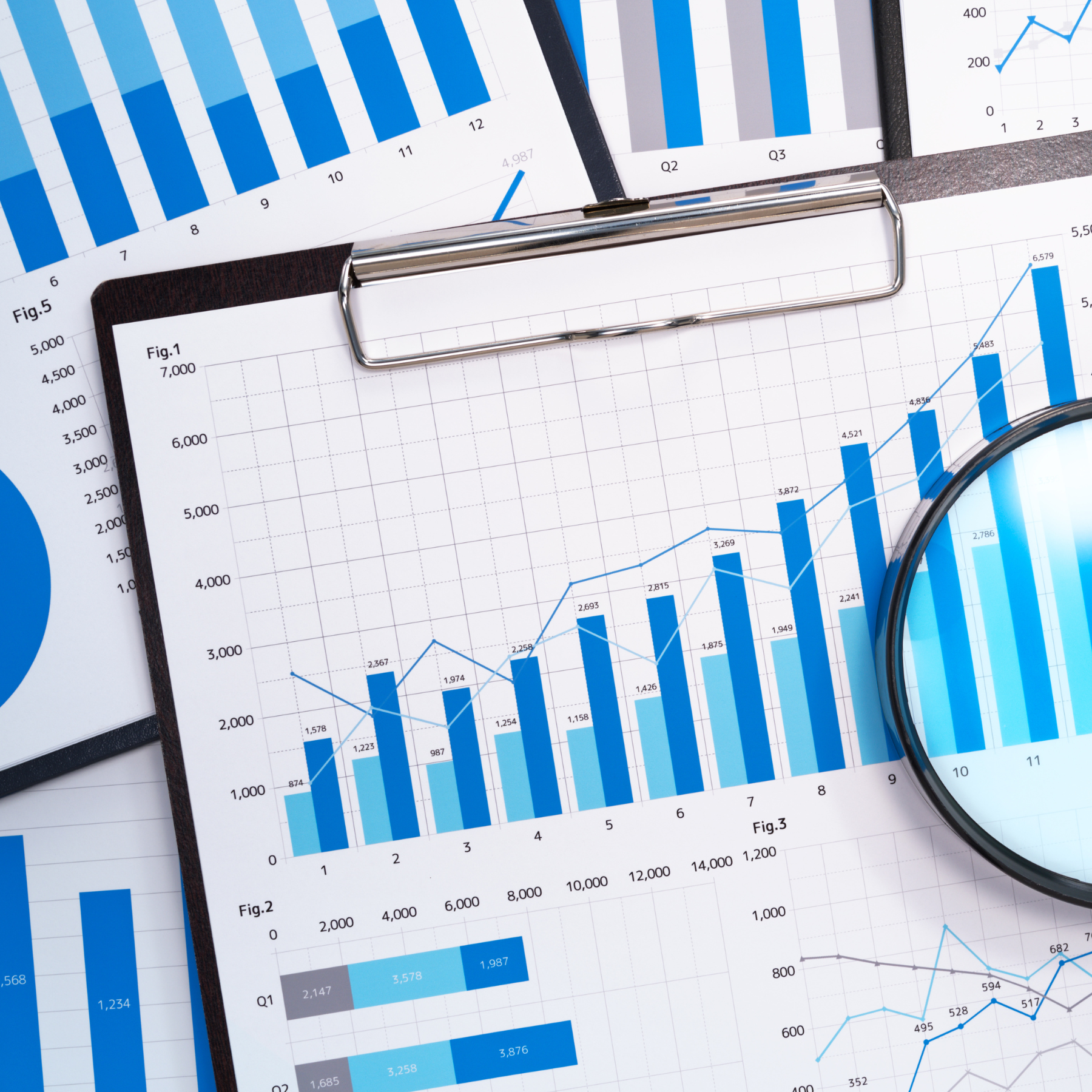 Business charts and benefits data on a desk representing BSP's strategic, data-driven approach to employee benefits plan design