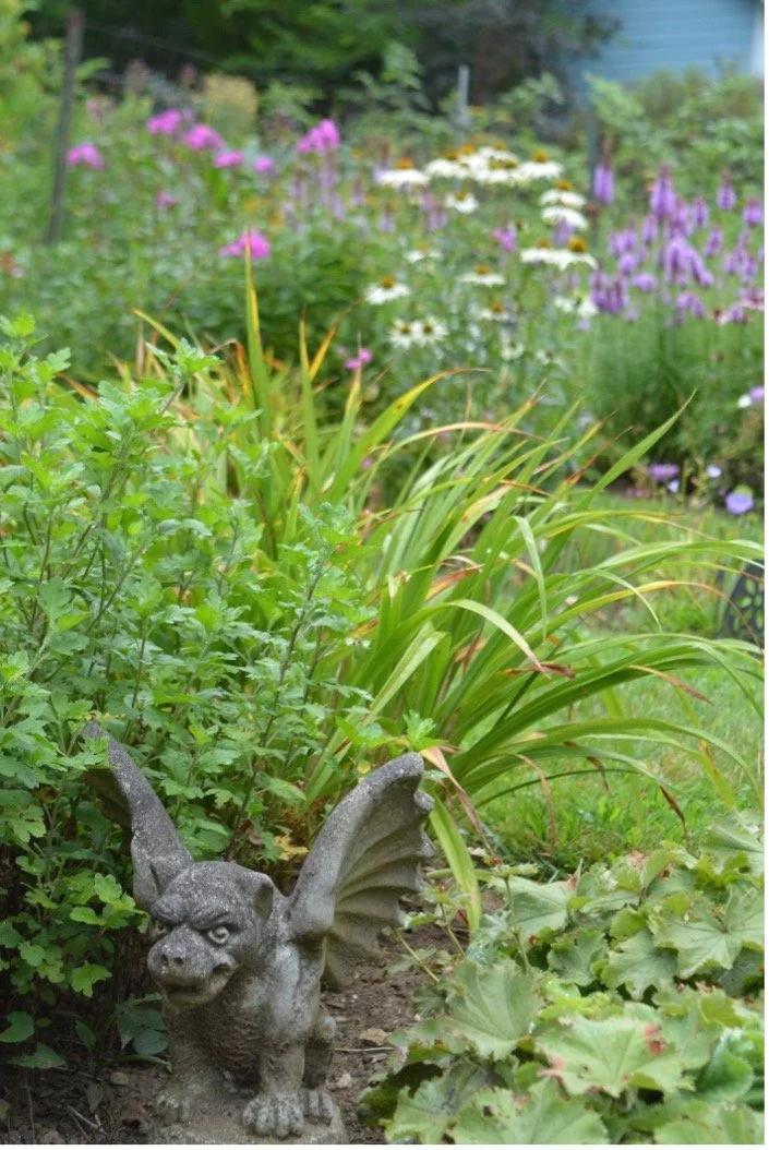 A gargoyle keeps watch over the garden