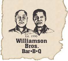 Vintage restaurant sign for Williamson Bros. Barbecue, featuring sketches of two men and the establishment date 1990.