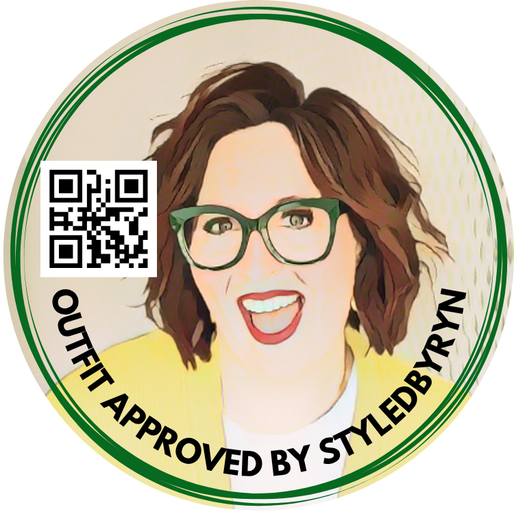 Circular sticker featuring a woman with short, wavy brown hair, green glasses, and red lipstick, smiling. The sticker has a green border and includes a QR code on the left side. Text around the border reads "Outfit Approved by StyledbyRyn."
