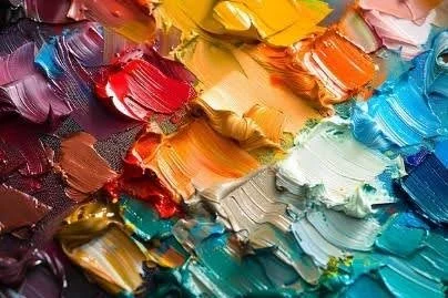 Close-up of textured paint swatches showing layered pigments in a range of saturated colors.