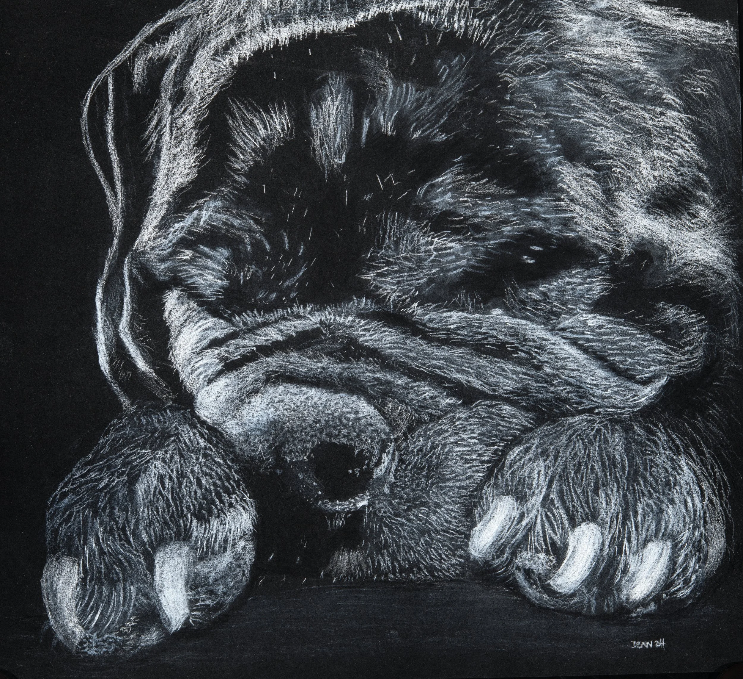 A detailed chalk drawing of a sleeping puppy resting its head and paws on a surface, with closed eyes and a calm expression.