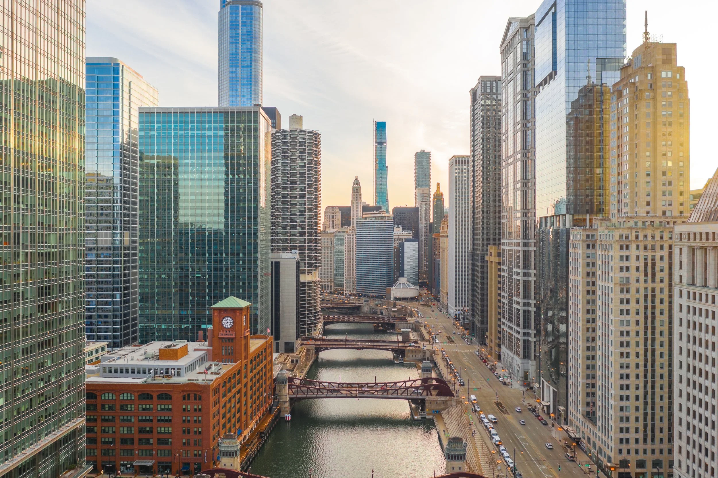 Cityscape of Chicago with high-rise buildings and river at sunset
