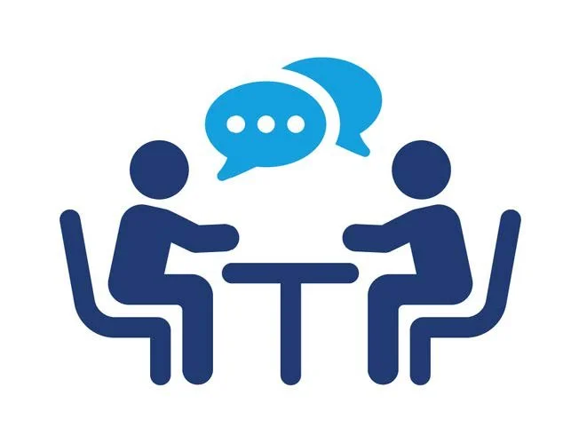 Two simplified human figures sitting at a table, engaging in conversation with speech bubbles above them.