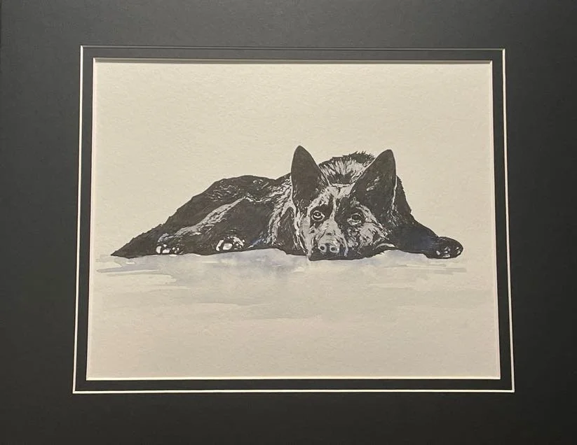 Black and white drawing of a dog lying down with its head resting on the ground, framed by a black border.
