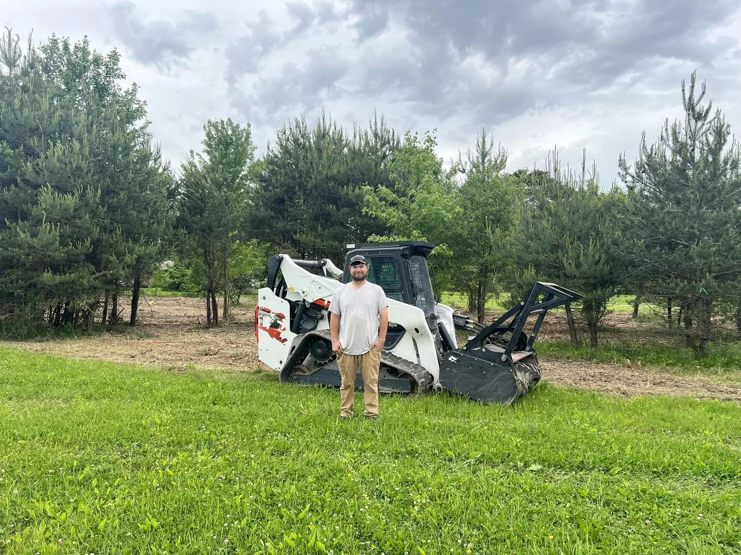 Sword Land Management owner Colten Sword in front of our Forestry Mulcher Machine