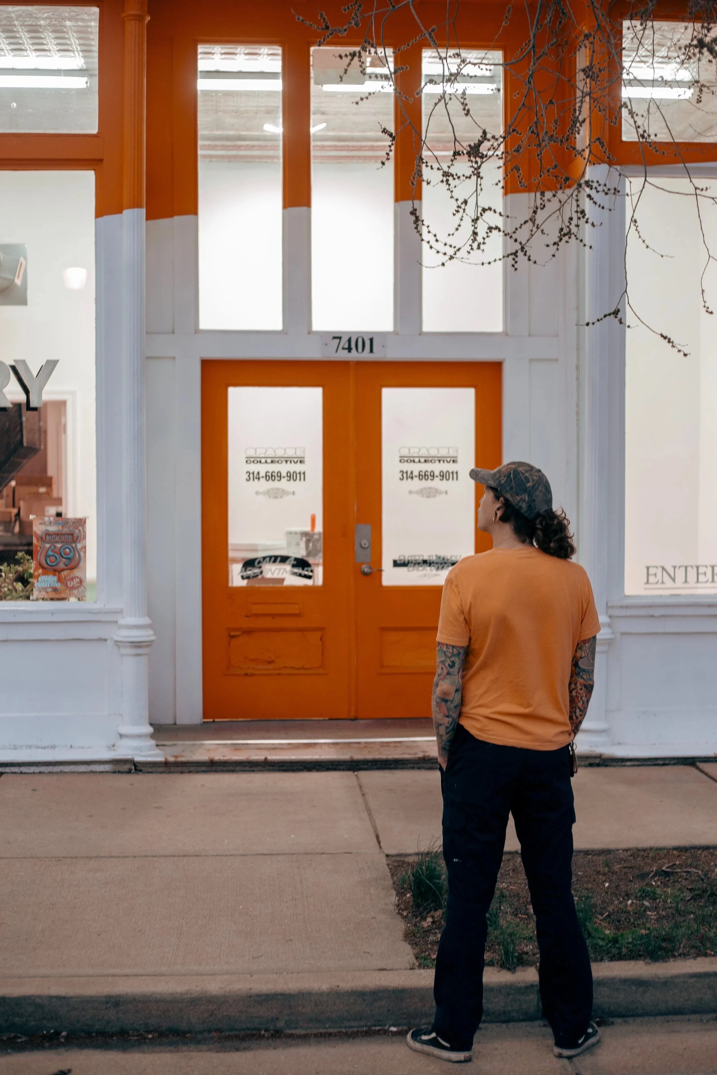 Jared Efferus admires the facade he designed at Opaque Union Screen Printing Shop in St Louis Missouri