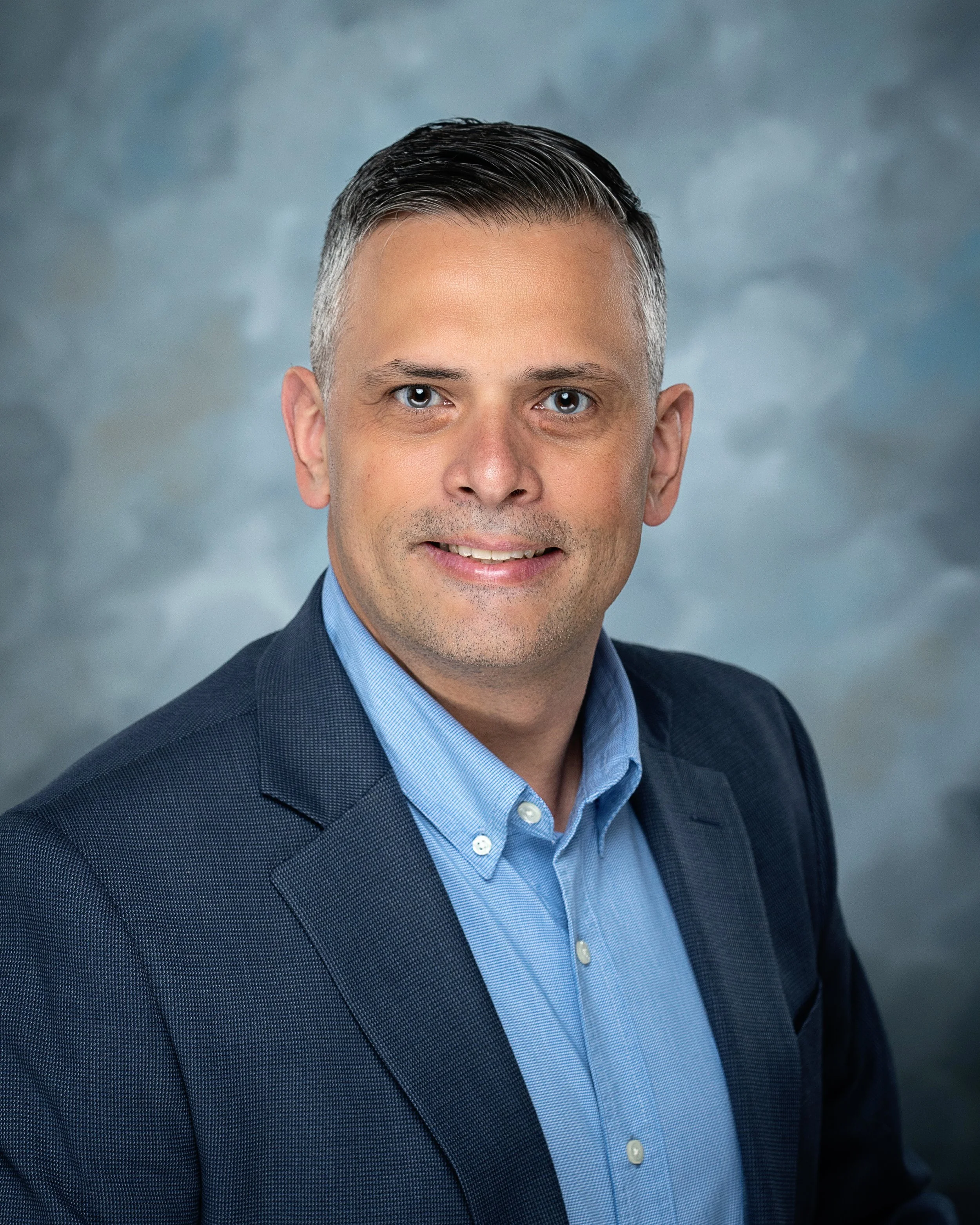 Attorney Jamie White headshot blue back ground(version 2)