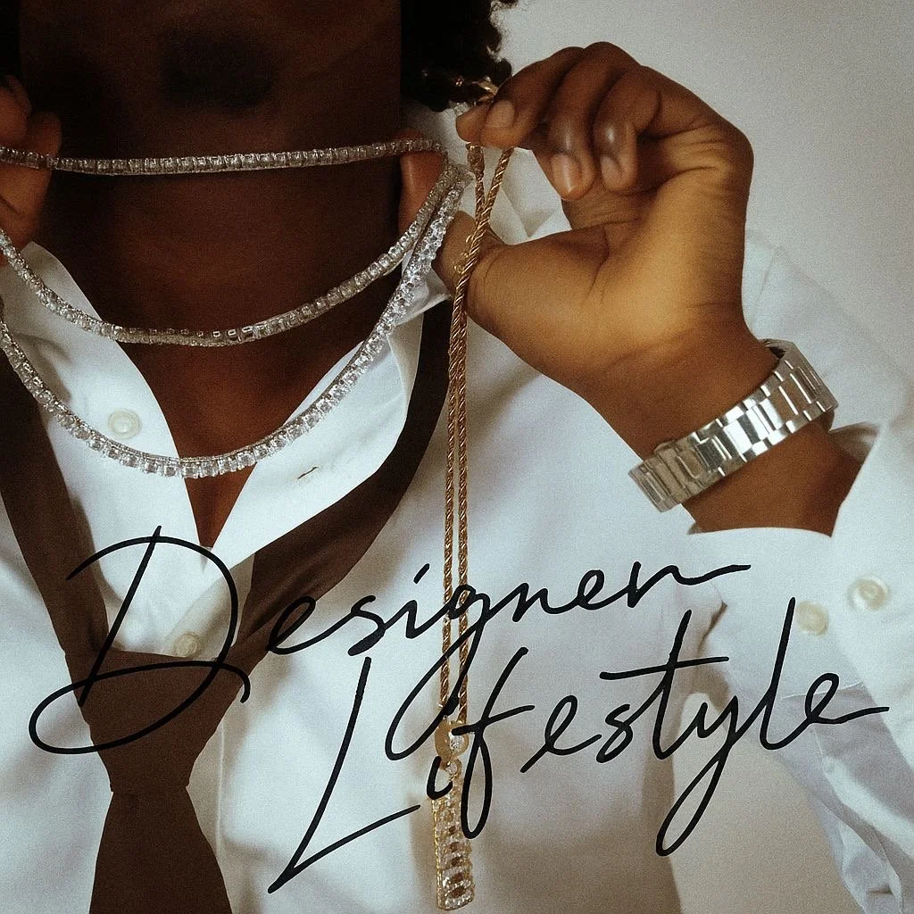 Close-up of a person wearing multiple diamond necklaces, a white shirt with a black tie, and a silver watch. The person is holding a gold chain necklace, and the text overlay reads 'Designer of Style.'