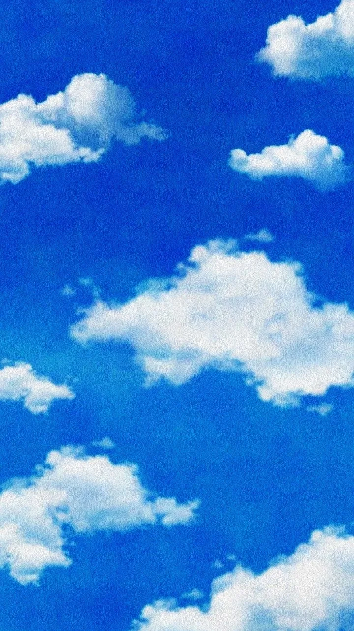 Blue sky with scattered white clouds.
