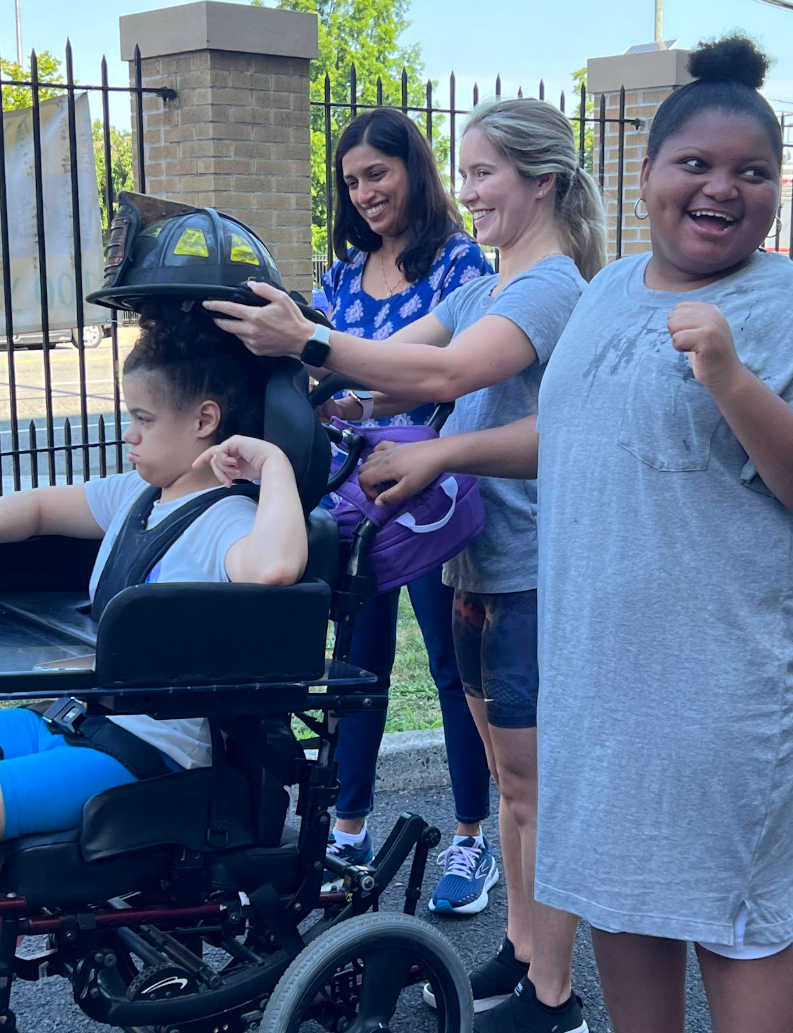 Students and staff share a laugh at the school gate