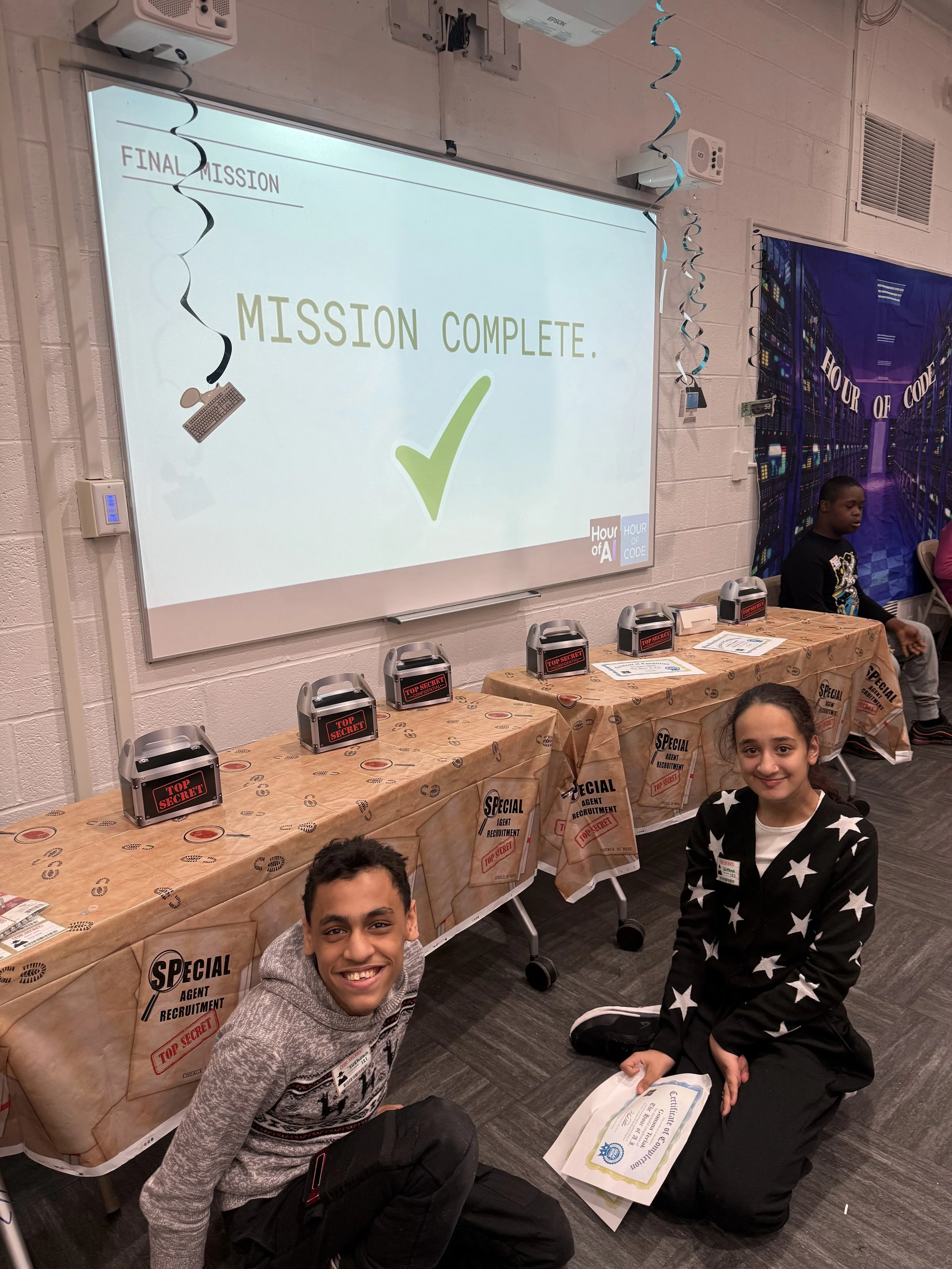 Two students celebrate finishing an Hour of Code mission
