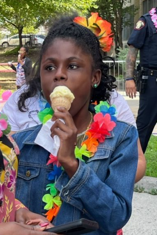 A student enjoys an ice cream cone at a summer celebration