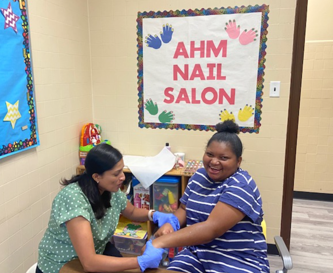 A student practices at the AHM Nail Salon