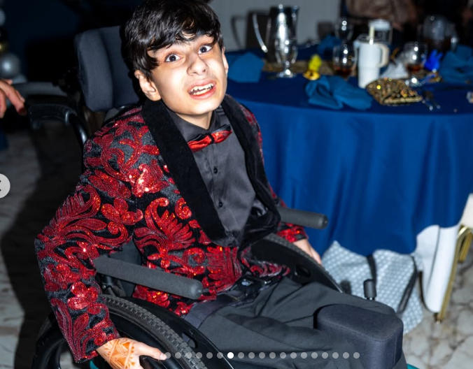 A student laughs at his table at prom