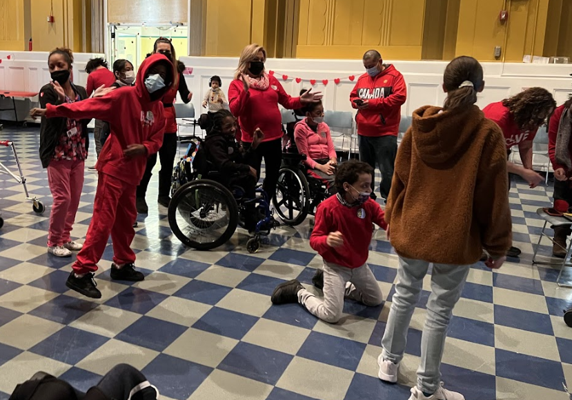 Students and staff celebrate at the holiday party in the gym