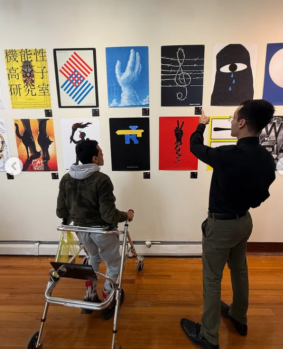 Students look closely at posters during an art gallery visit