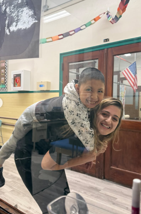 Two members of the AHM community share a hug in the hallway