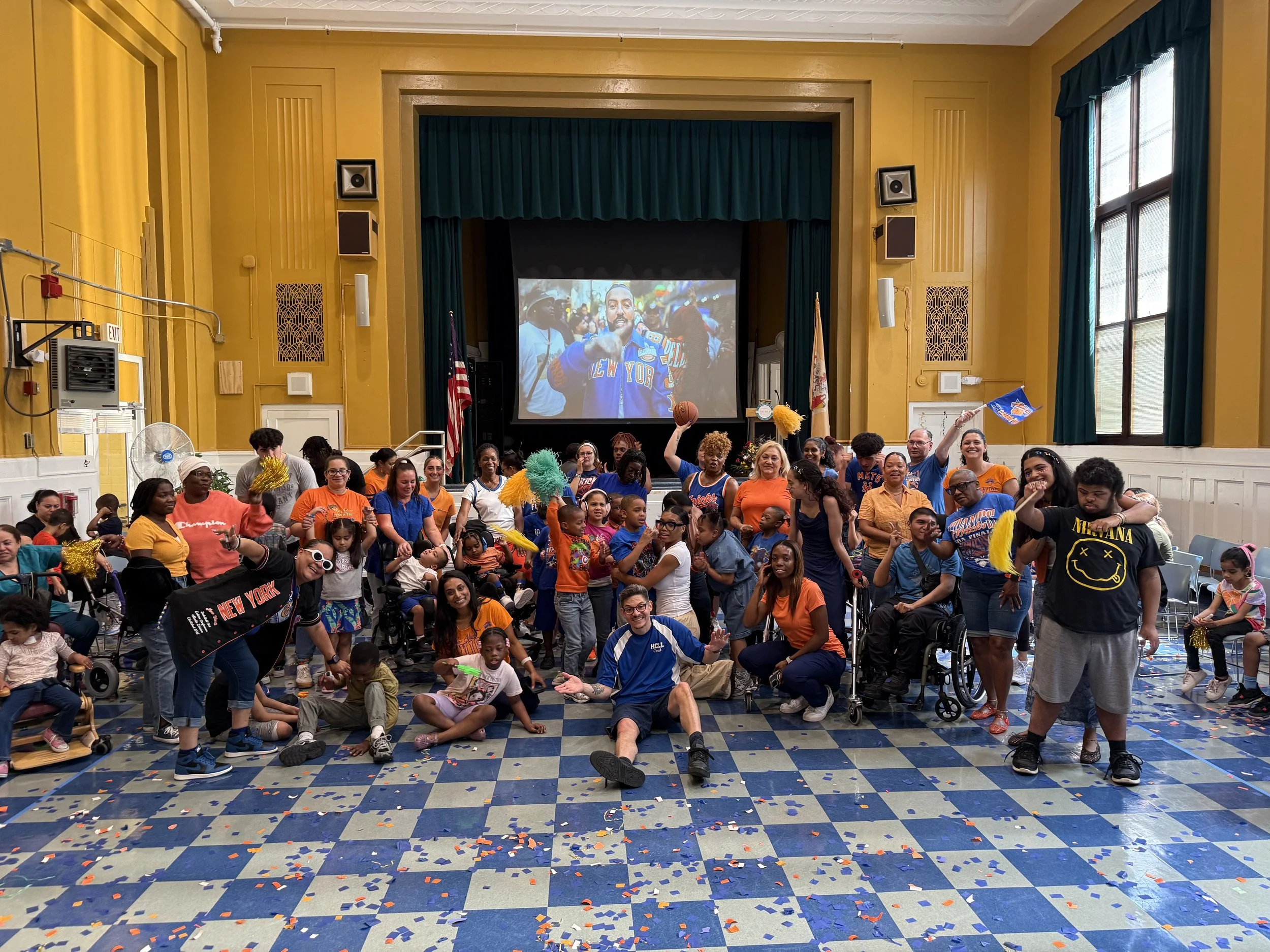 Students and staff in orange at a school spirit assembly